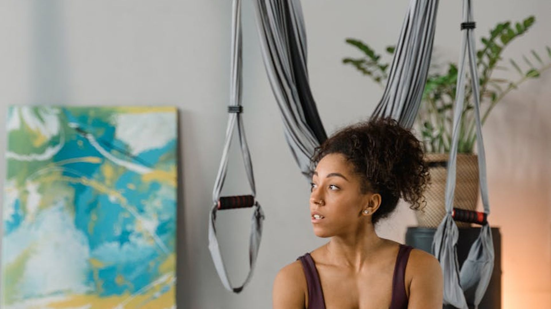 Atmospheric yoga studio with soft natural light and plants.