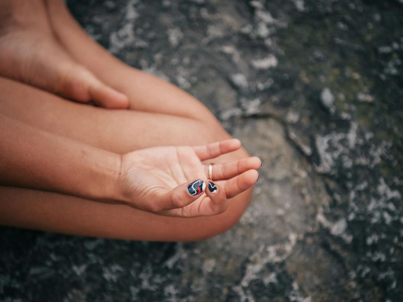 Detailed close-up of hands in a yoga mudra position.