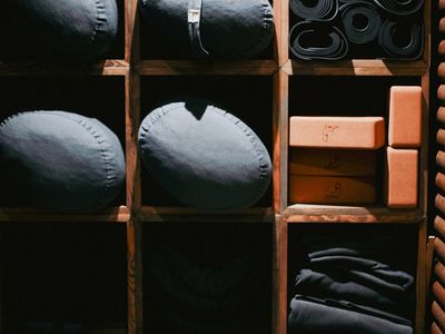 Yoga blocks and a strap neatly placed on floor.